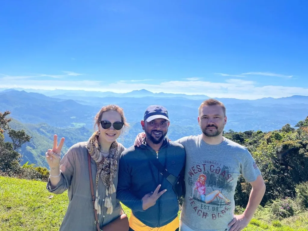 Travelers enjoying a mountain viewpoint in Sri Lanka